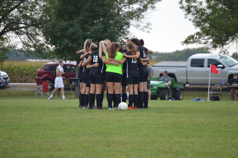 Women's Soccer Team huddled together at NIACC